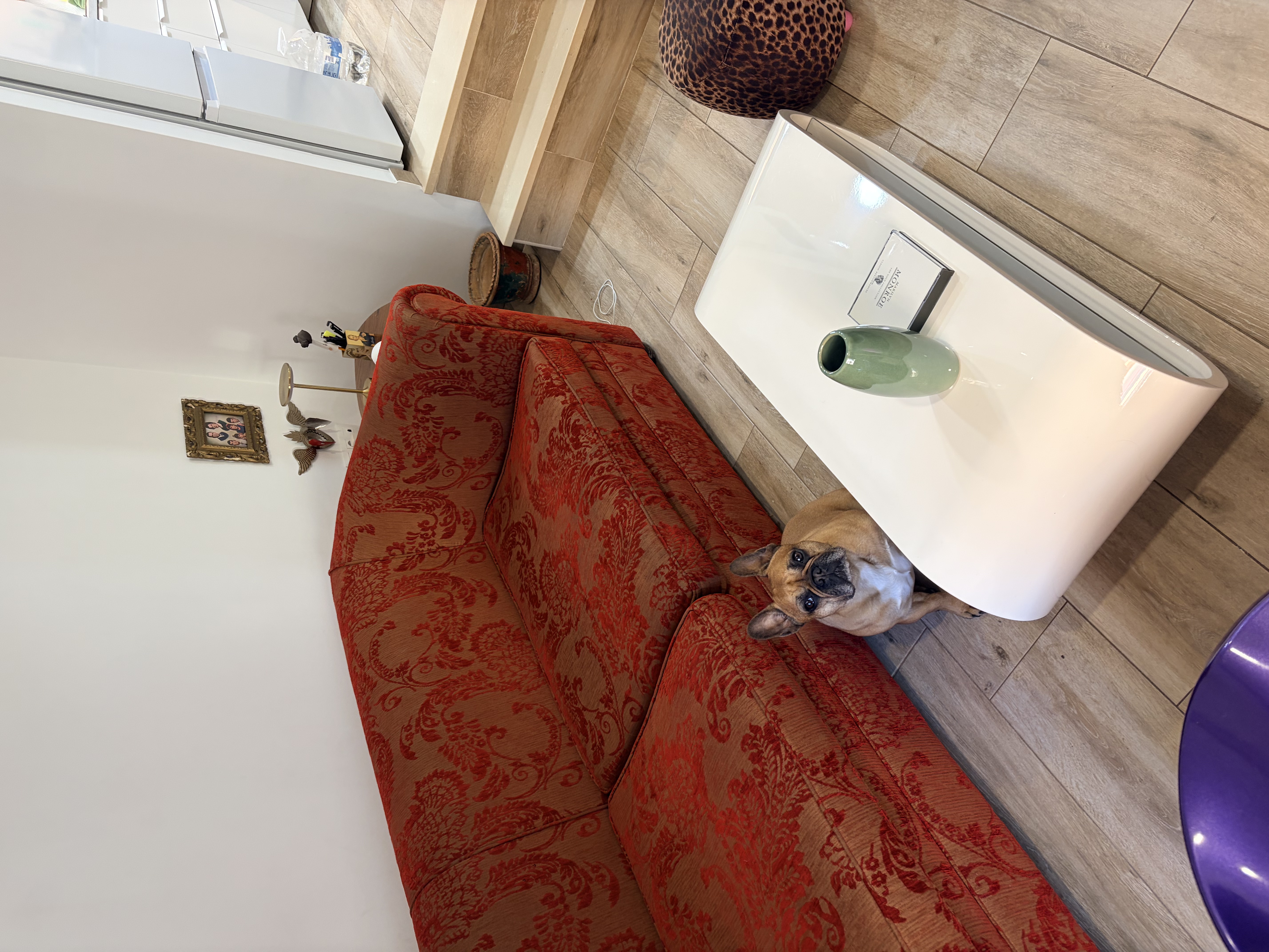 Daytime view of living room with red sofa