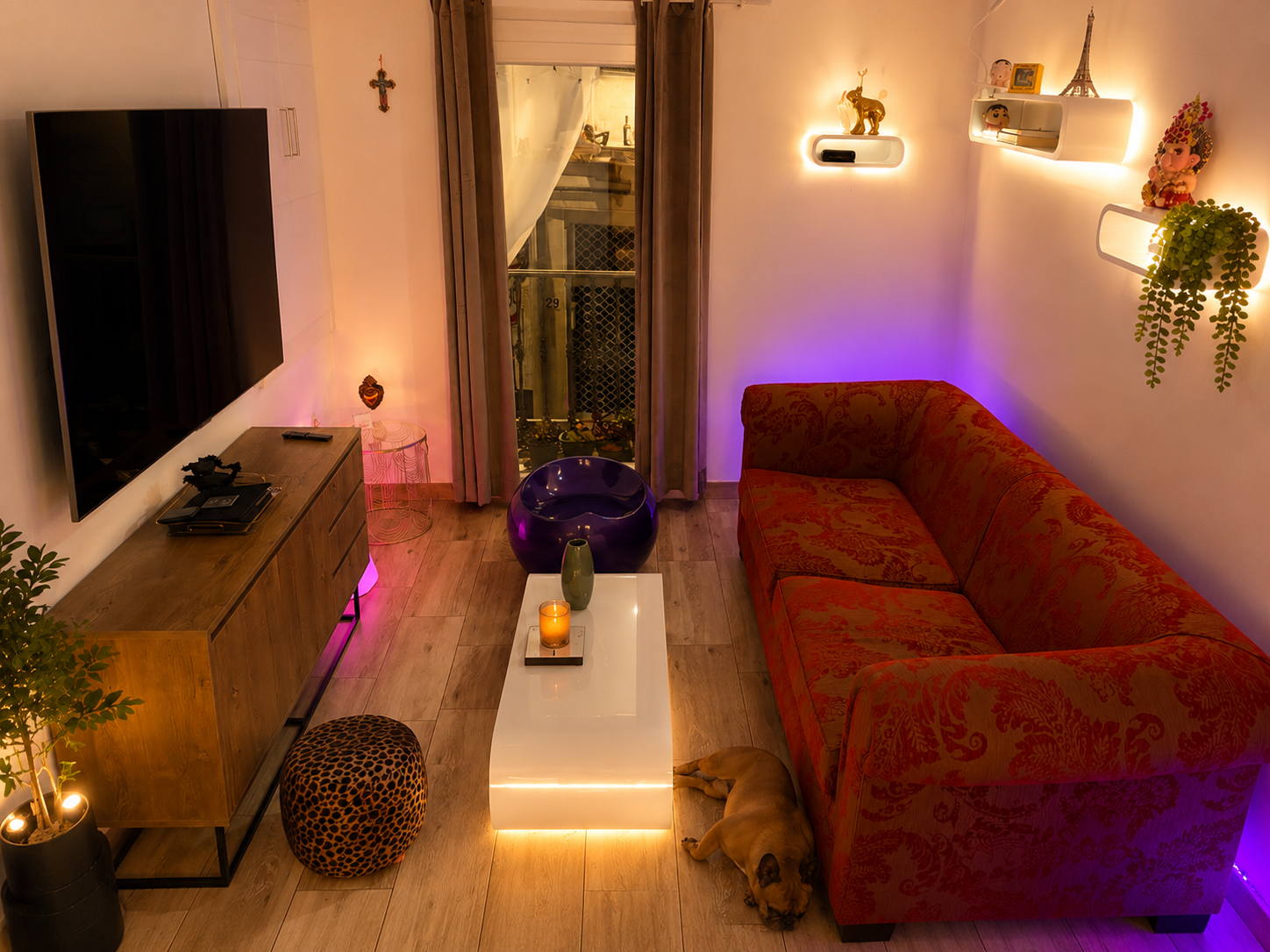 Red Velvet apartment living room with warm lighting and a red sofa